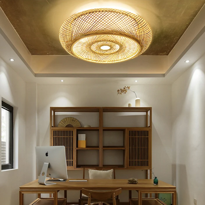 Minimalist Zen bamboo hanging lamp with a circular geometric weave design illuminating a warm beige room.