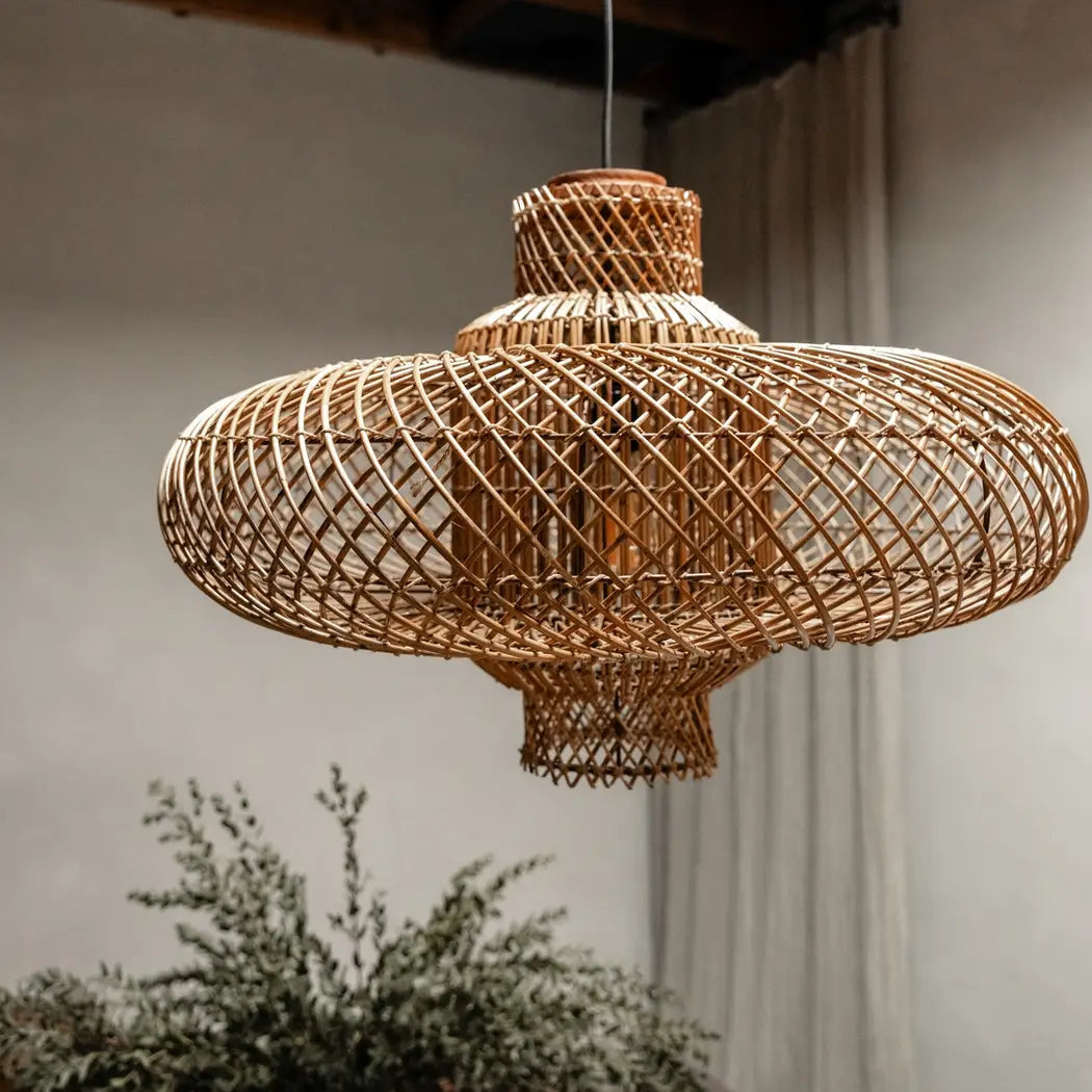 A unique handmade rattan pendant light in a bohemian interior, perfect for a cozy living space.