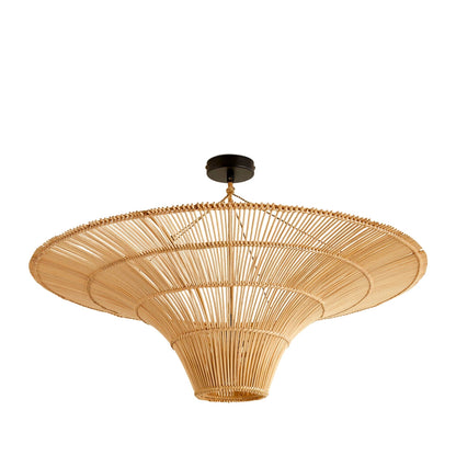 Oversized boho wicker chandelier emitting warm ambient lighting in a coastal Santorini dining space
