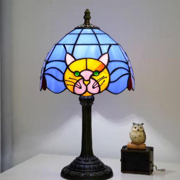 Artistic black cat Tiffany bedside table lamp casting a warm, colorful glow for cozy master bedroom nightstands.