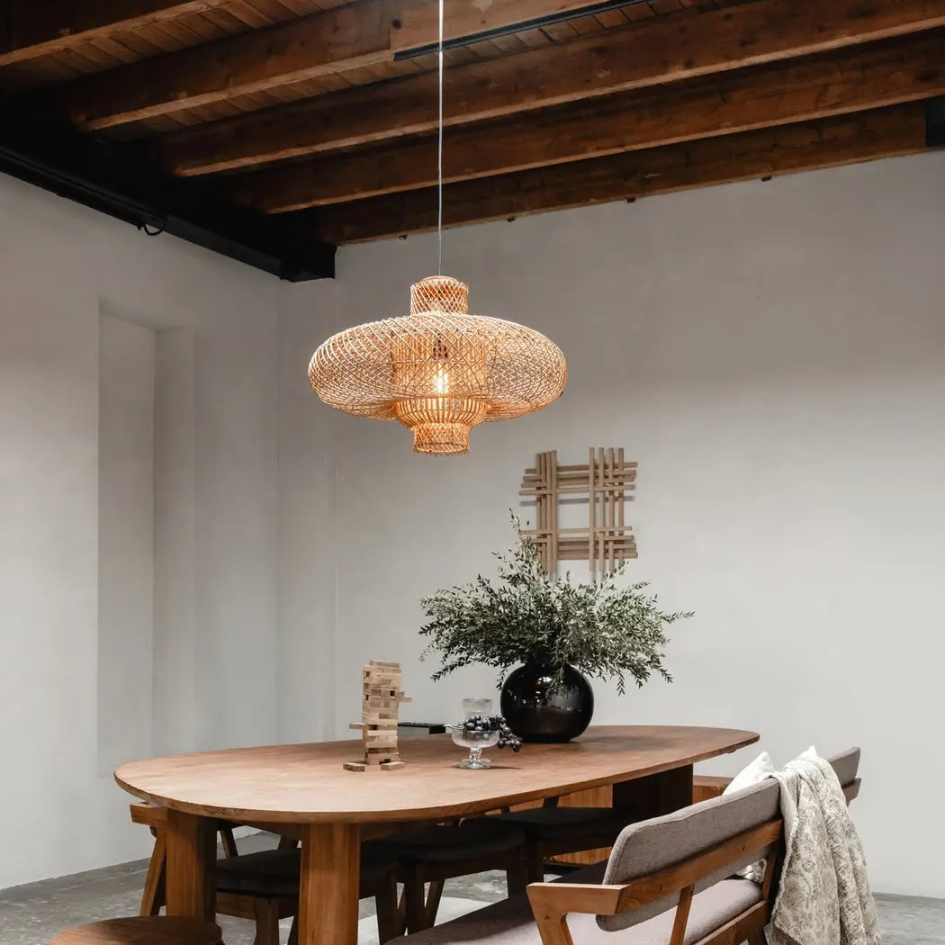 Beautiful handcrafted rattan lighting piece hanging above a dining area, adding warmth to home interiors.