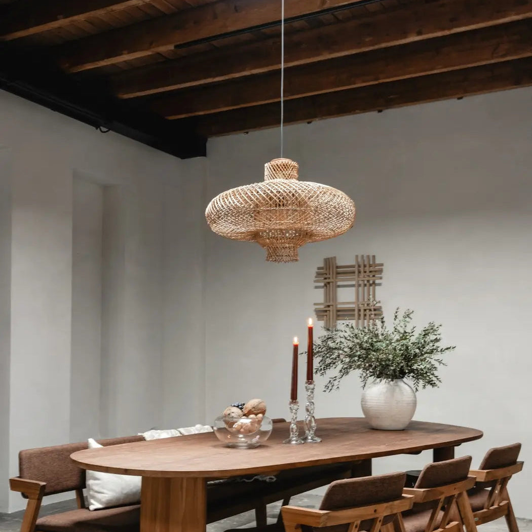 Beautiful handcrafted rattan lighting piece hanging above a dining area, adding warmth to home interiors.