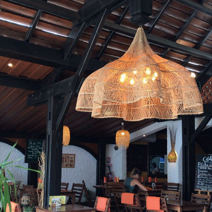 Handcrafted rattan pendant lamp with intricate flower patterns, perfect for boho and minimalist home decor.