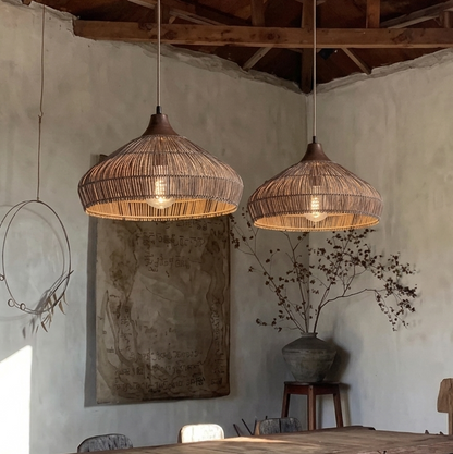 A rustic handwoven rattan pendant light featuring a decorative wooden top mount.