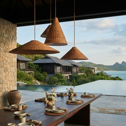 Set of three elegant woven rattan pendant lights hanging over a dining table in a luxury restaurant inspired by Amanoi Vĩnh Hy, creating a serene and sophisticated atmosphere