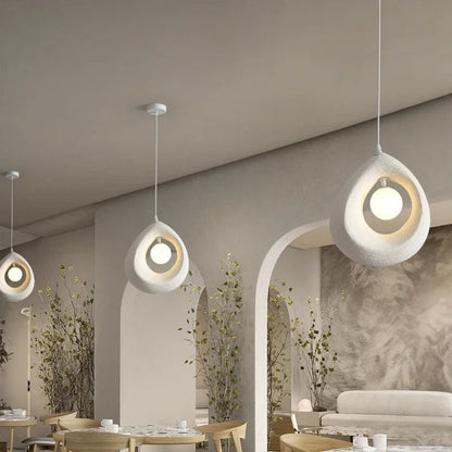 Minimalist pebble-shaped hanging lamp in textured off-white finish