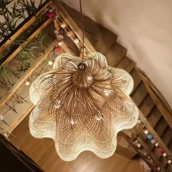 Scalloped rattan flower petal pendant light hanging in a Zen dining room above a rustic wooden table with a mini fireplace
