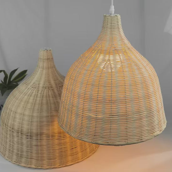 A classic handwoven rattan pendant light with a clean white ceiling fixture.
