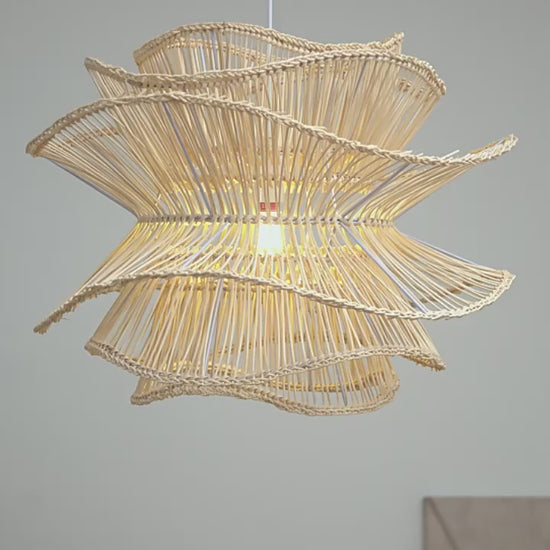 Eco-friendly natural fiber pendant lamp in a wavy, flower-like silhouette for coastal and boho decor