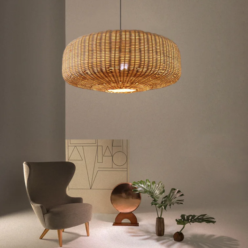 Two large woven rattan pendant lights illuminating a rustic wooden kitchen island with bar stools.