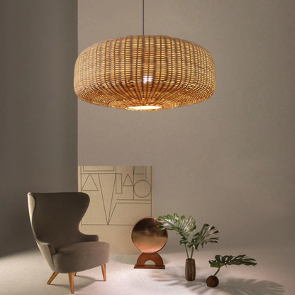 Two large woven rattan pendant lights illuminating a rustic wooden kitchen island with bar stools.