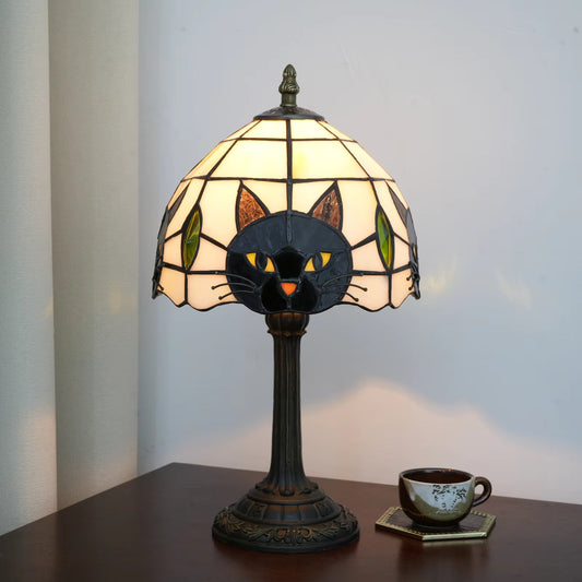 Charming Tiffany-style stained glass table lamp featuring a black cat design, providing vibrant ambient lighting for living rooms.