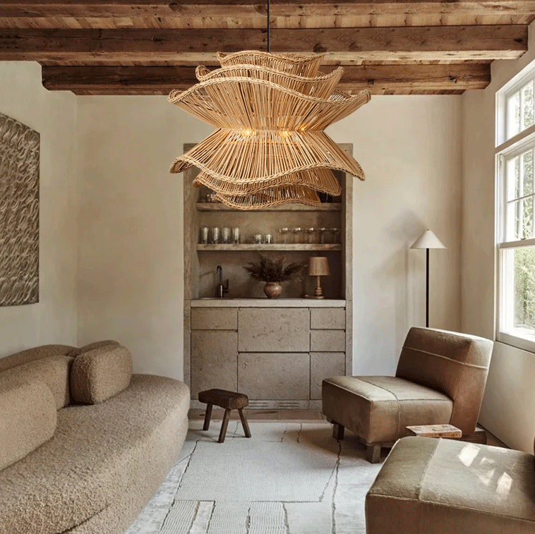 Made Goods Alondra rattan pendant light with a wavy layered floral design hanging against a white background.