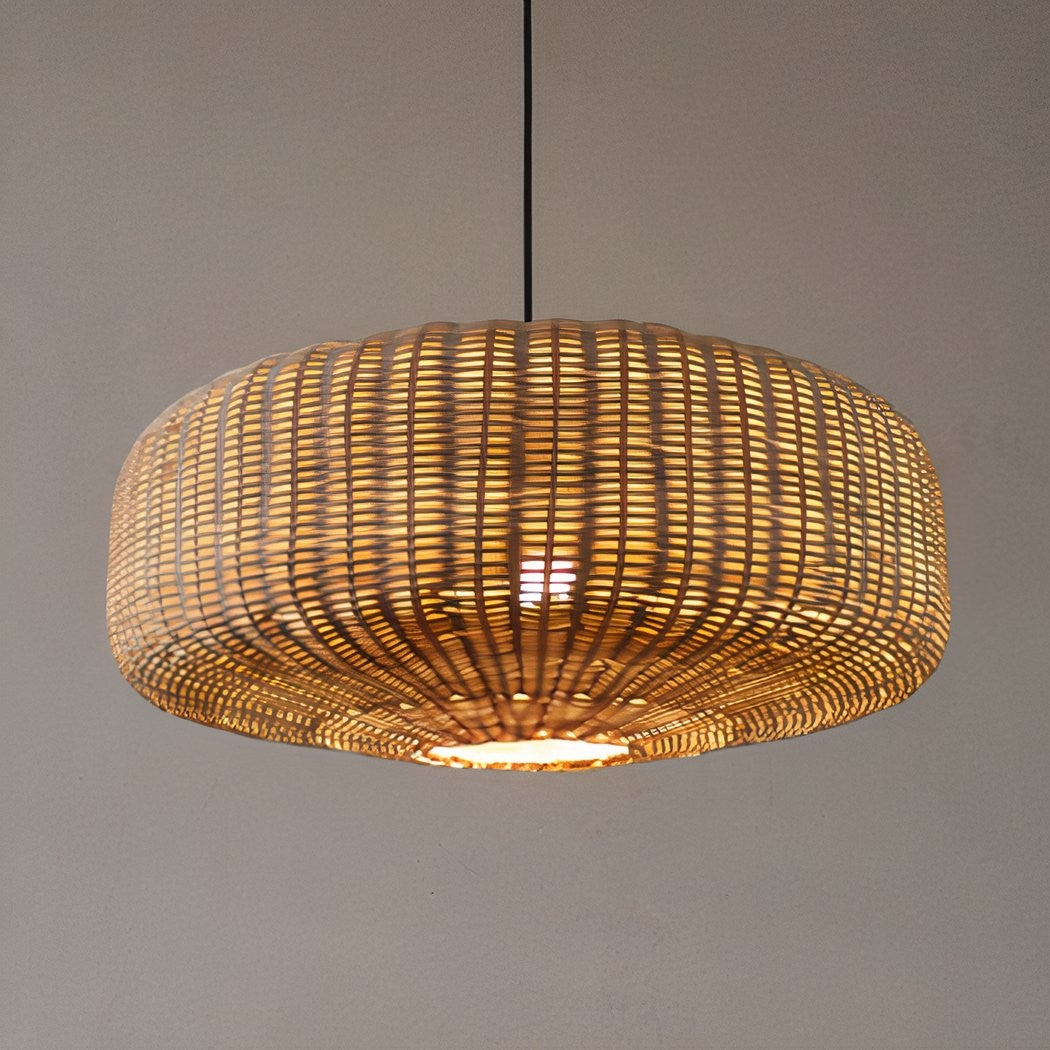 Close-up of natural woven bamboo ceiling lamps glowing warmly in a country-style kitchen.