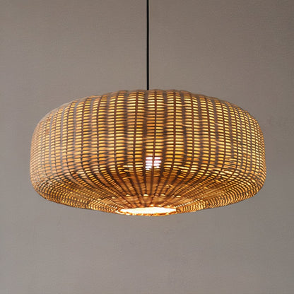 Close-up of natural woven bamboo ceiling lamps glowing warmly in a country-style kitchen.